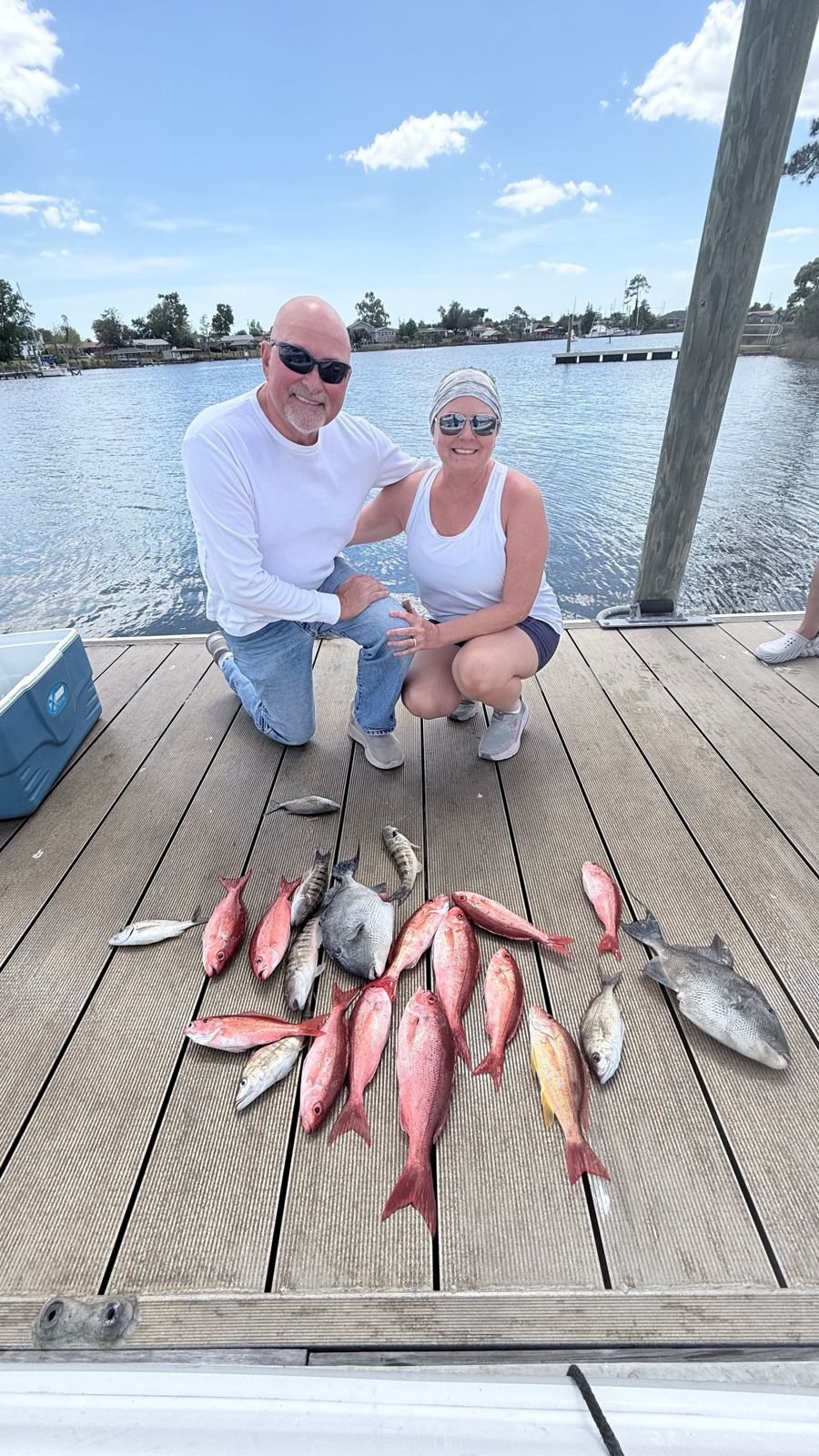 Successful fishing trip displaying Grey Triggerfish and Lane Snapper catch on dock in Panama City FL