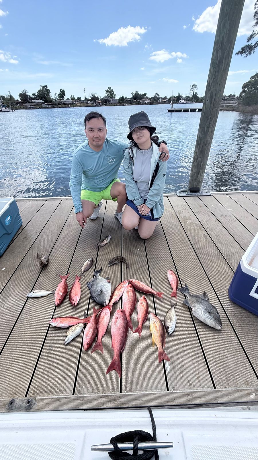 Fishing charter catch of grey triggerfish, lane snapper, and bluefish displayed on boat dock in Panama City FL